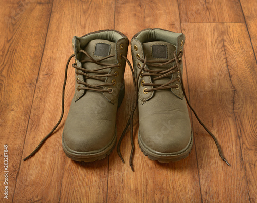 pair of mountain shoes on wooden table