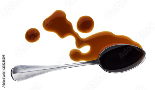 Soy sauce with spoon isolated on white background. Top view