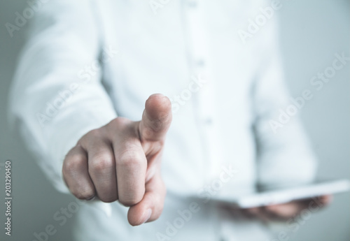 Caucasian businessman pointing and touching on a touch screen.