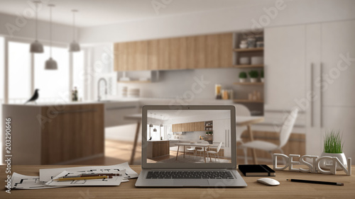 Architect designer desktop concept, laptop on wooden work desk with screen showing interior design project, blurred draft in the background, modern kitchen idea template