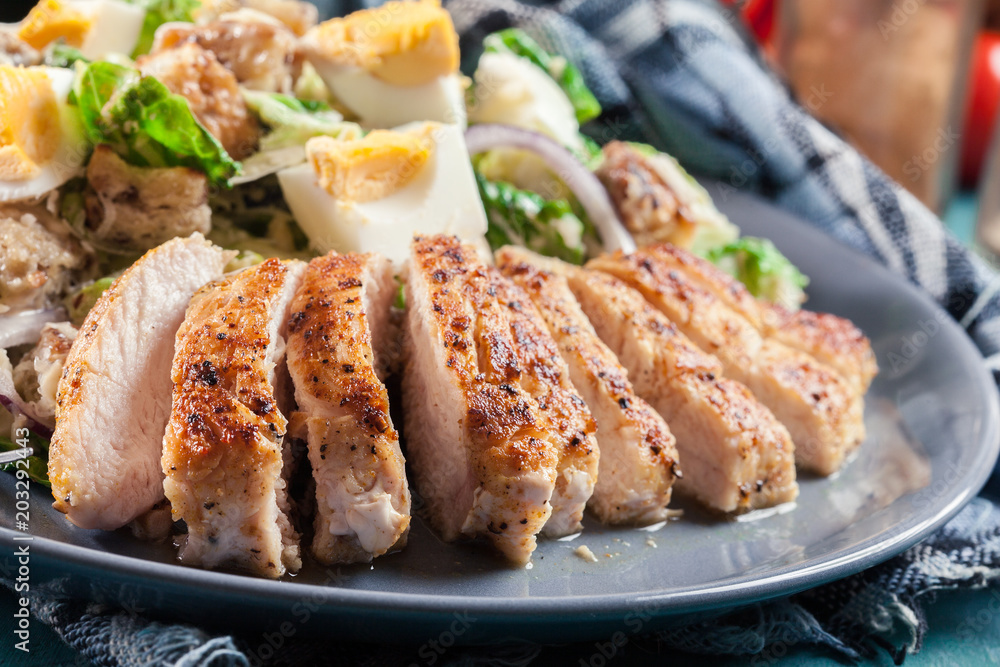 Healthy caesar salad with chicken, eggs and croutons