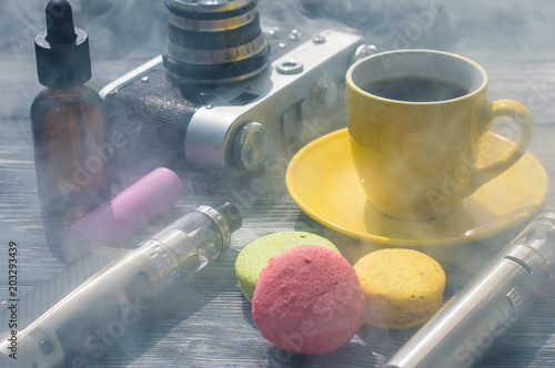 Still life with e-cig and jiuce on the wooden background photo