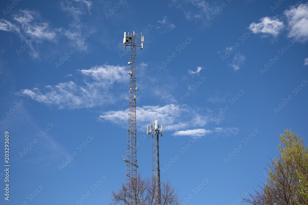 Obraz premium Telecommunication tower in European Union. Dark blue sky with white clouds in the background