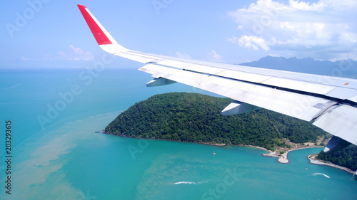 Wallpaper Mural LANGKAWI, MALAYSIA - APR 4th 2015: View from airplane window with wing of an airplane landing on an tropical island Torontodigital.ca