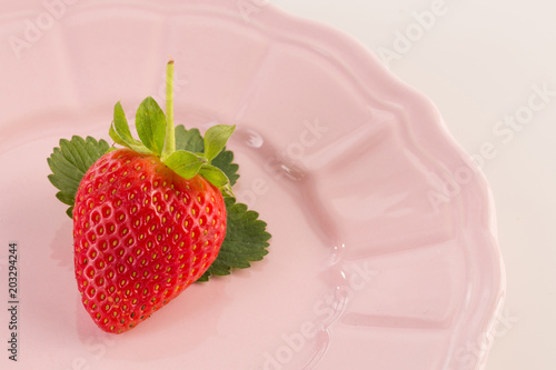 Fresh strawberry on vintage plate