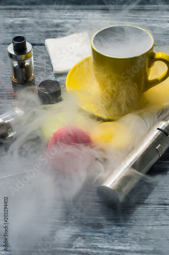 Still life with e-cig and jiuce on the wooden background photo