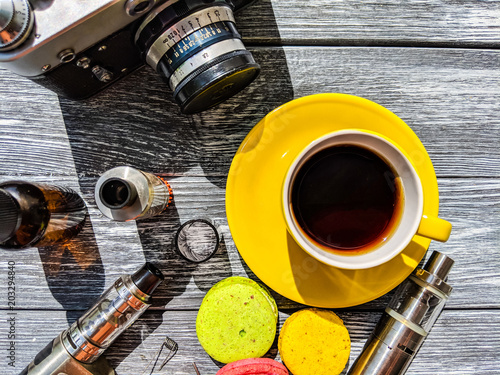 Still life with e-cig and jiuce on the wooden background photo