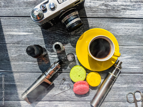 Still life with e-cig and jiuce on the wooden background photo