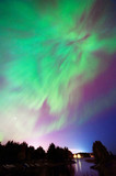 Aurora Borealis, Northern lights, above night landscape in Finland.