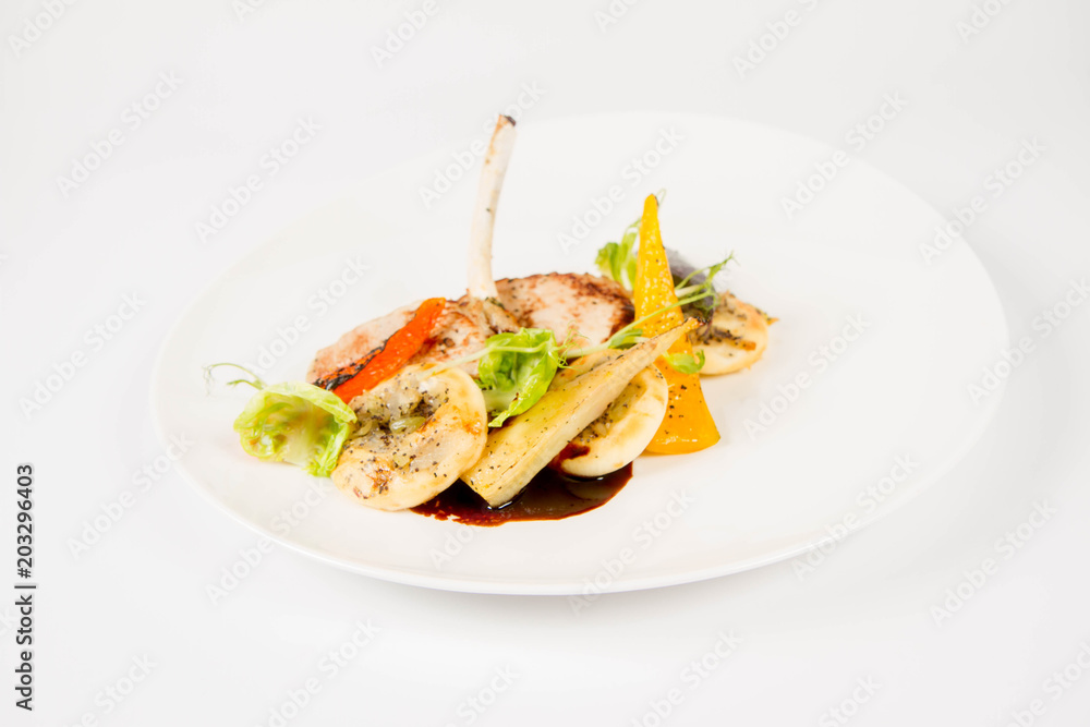 Meat dish with vegetables on a white background