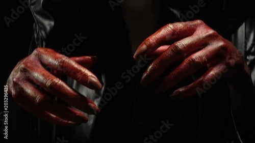 Blood hands of young woman in image