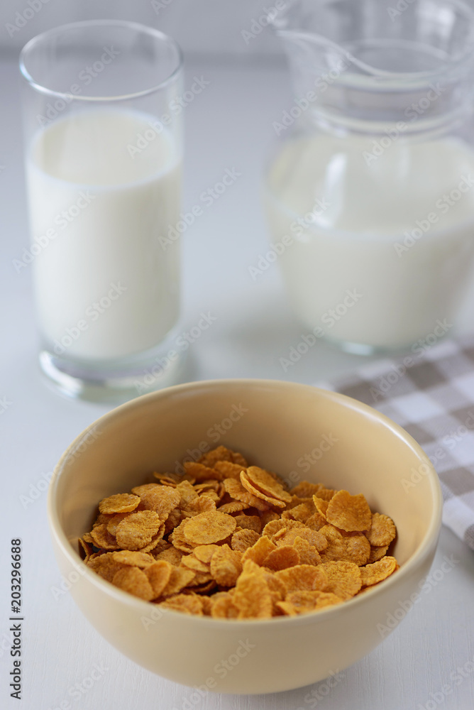 cornflakes with milk in a plate on a white table cornflakes with milk in a plate on a white table