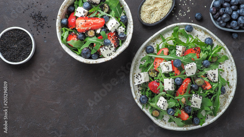 Salad with arugula, feta, strawberry, blueberry