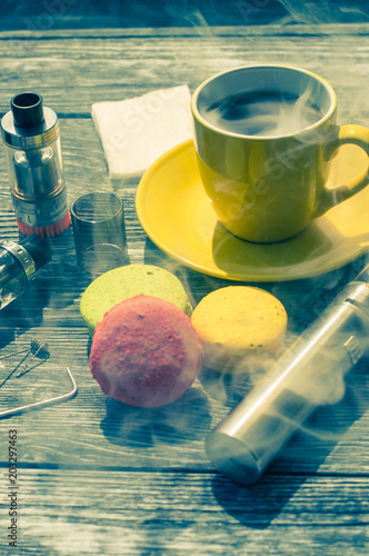 Still life with e-cig and jiuce on the wooden background photo