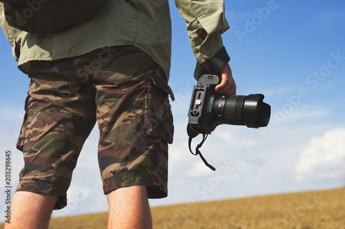 Photographer holding a camera outdoors