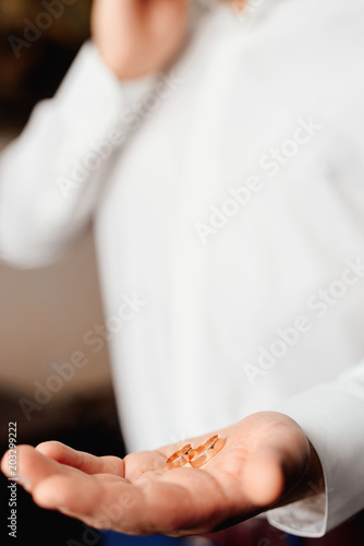 wedding rings in a man's hand