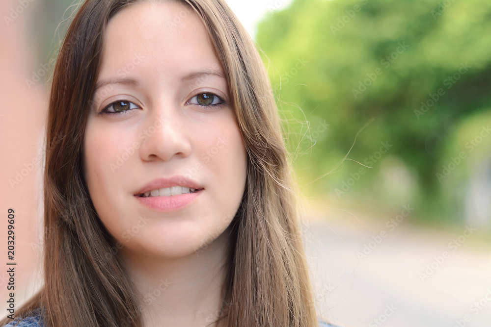 Close up of a young woman outdoors.