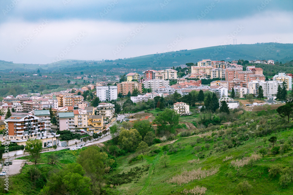 View of the city from a height, a city between the mountains, частные houses on a hill