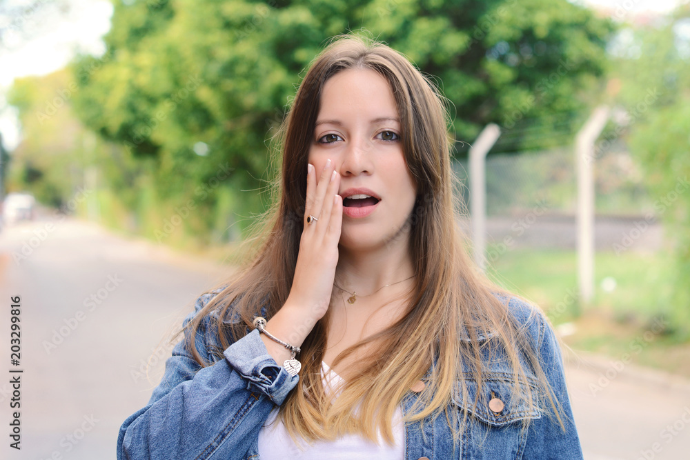 Young woman with surprised expression. Outdoor. Young woman with surprised expression. Outdoor.