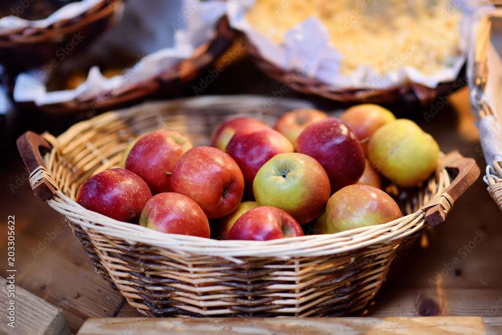 Fresh bio apples in straw basket on farmer market in Strasbourg, France Fresh bio apples in straw basket on farmer market in Strasbourg, France