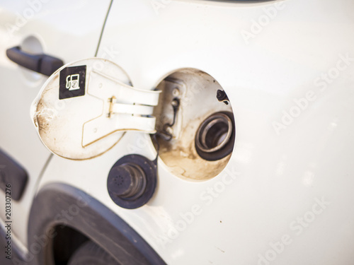 close up hand open and close gas tank cap white car to fill it with fuel © Mihail