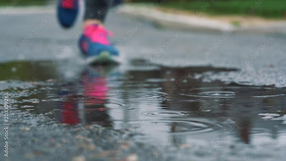 Close up slow motion shot of legs of a runner in sneakers. Female ...