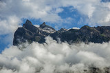 View of snowy peaks and alpine mountains panorama with blue sky and clouds in Saint-Gervais-Les-Bains/Le Fayet. Near the Mont Blanc in the French Alps.
