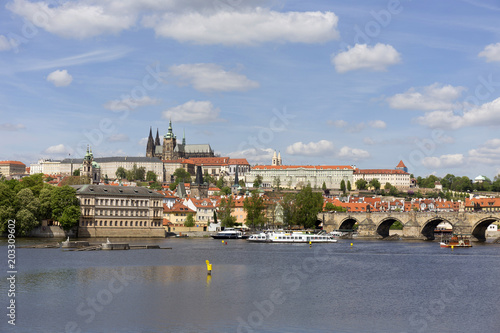 Spring green Prague Lesser Town with gothic Castle and Charles Bridge above River Vltava in the sunny Day, Czech Republic © Kajano