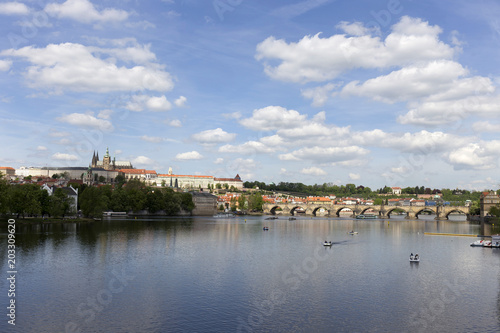 Spring green Prague Lesser Town with gothic Castle and Charles Bridge above River Vltava in the sunny Day  Czech Republic