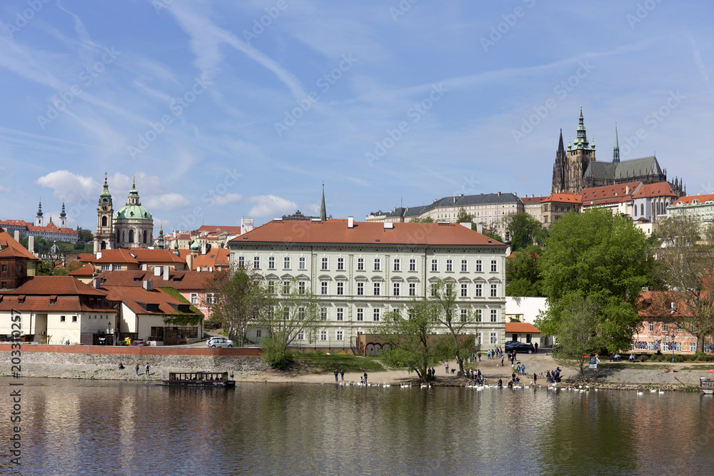Spring green Prague Lesser Town with gothic Castle above River Vltava in the sunny Day, Czech Republic