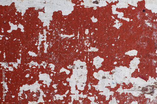 Distressed painted wall texture with red paint stains and white background. Painted texture in obsolete paint. © Elya.Q