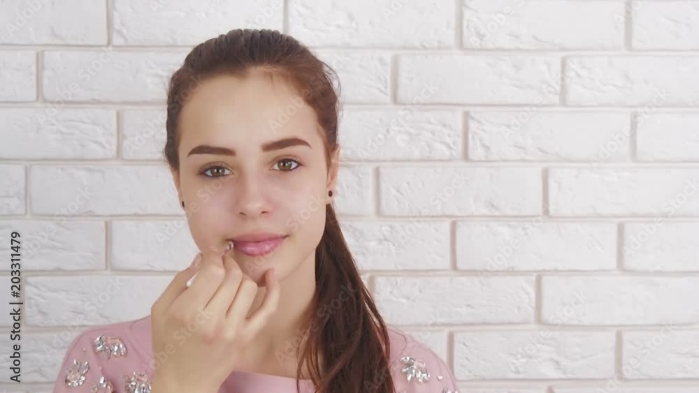 Makeup of a teenager. The girl paints lips. Makeup of a teenager. The girl paints lips.