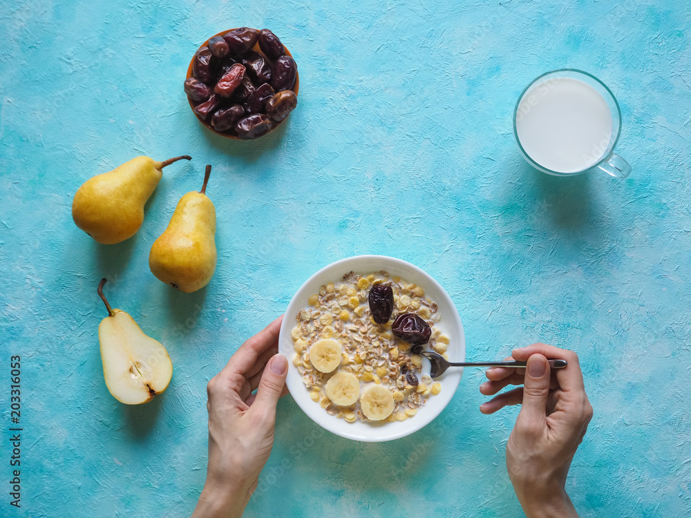 Fototapeta premium Milk and granola. Traditional european breakfast. Muesli, dates and fresh pears