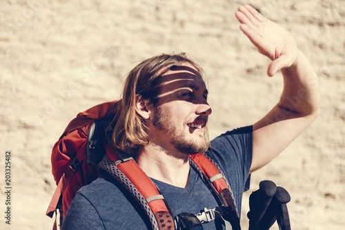 Hipster man traveling with backpack photo