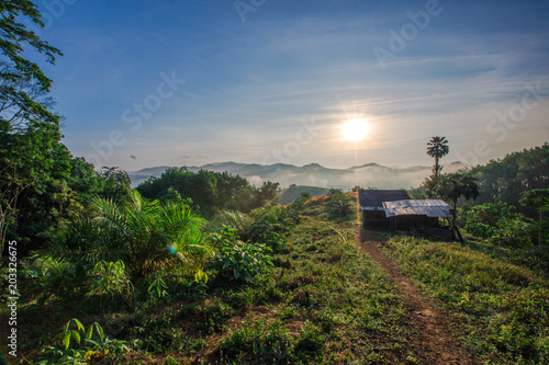 House or cottage at the foot of the hill. For temporary residence of gardeners. Morning light The atmosphere of beautiful nature (Ranong Province, Thailand)