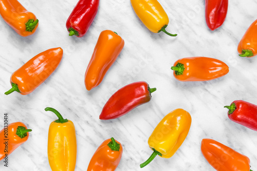 Colorful sweet peppers on marble background