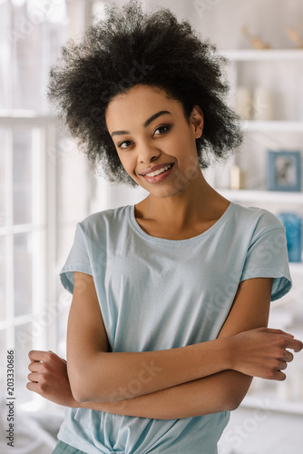 Young african american woman smiling posing at home
