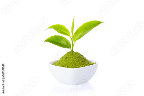 Powder green tea in cup and green tea leaf on white background