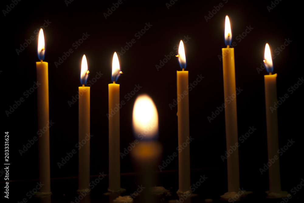 burning candle isolated on black background burning candle isolated on black background