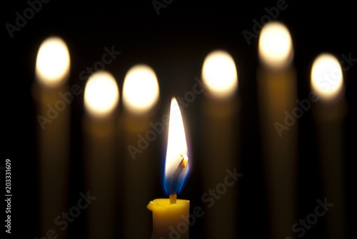 burning candle isolated on black background