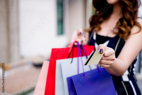 woman holding credit card and shopping bag, shopping concept