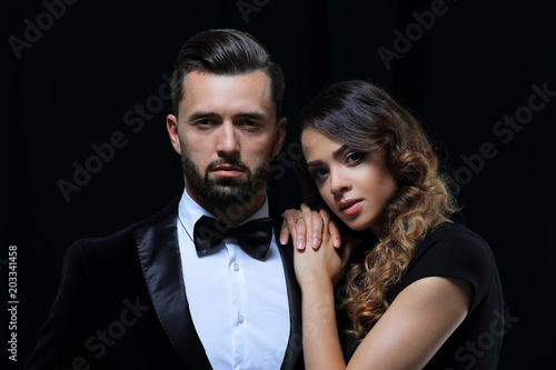 fashion studio photo of beautiful couple in elegant clothes