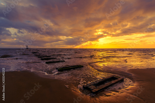 Golden sunset on Crosby Beach, Liverpool, England, UK