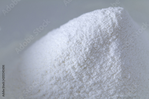 Closeup of a pile of white all-purpose wheat flour isolated with copy space