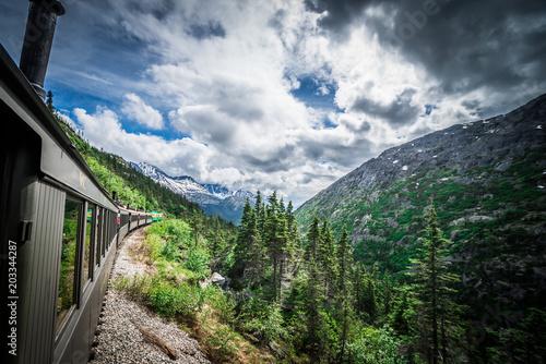 The White Pass and Yukon Route on train passing through vast landscape © digidreamgrafix