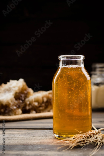 Linden honey in a transparent glass bottle