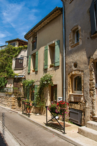 Street view with stone houses in the center of the village of Chateauneuf-du-Pape  blue sky and sunny day. Located in the Vaucluse department  Provence-Alpes-C  te d Azur region in southeastern France