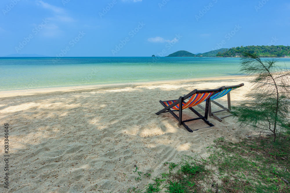 Beach chairs on the white sand beach and tropical sea in Thailand. Beach chairs on the white sand beach and tropical sea in Thailand.