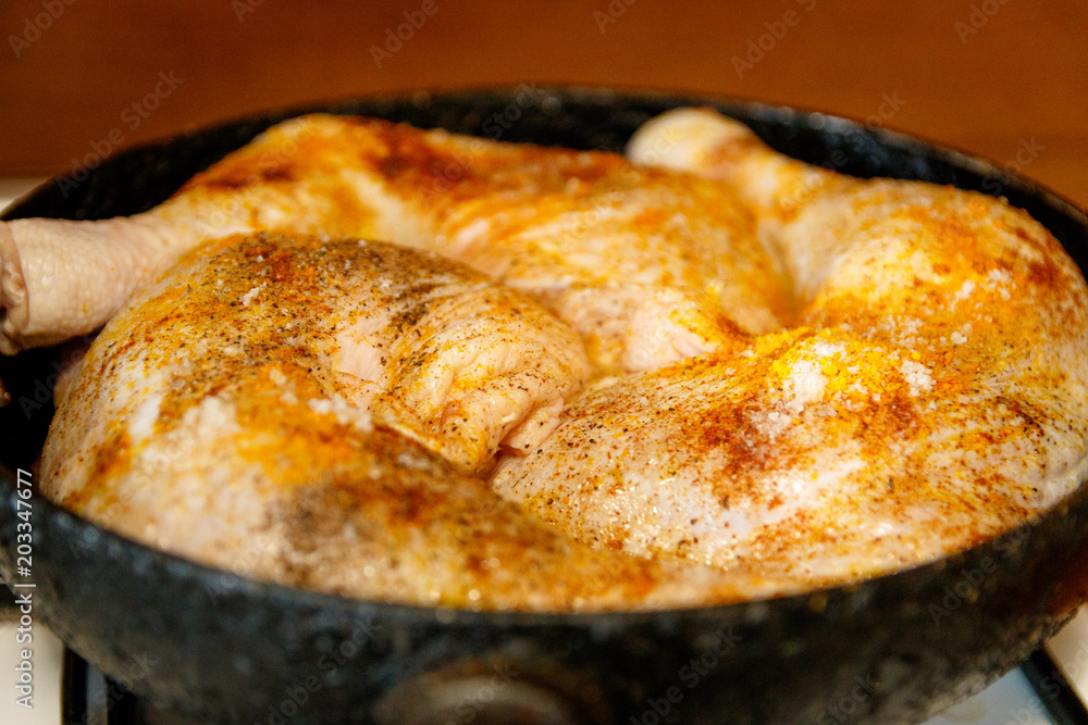 Raw chicken legs with spices on it. In a frying pan. Raw chicken legs with spices on it. In a frying pan.
