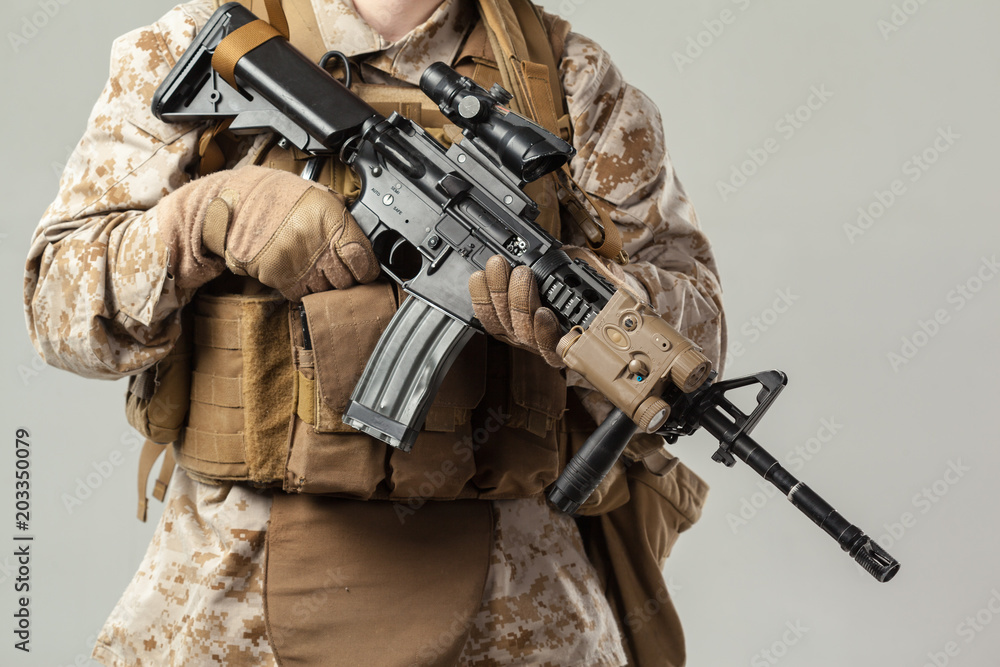 Fototapeta premium Soldier in camouflage holding rifle